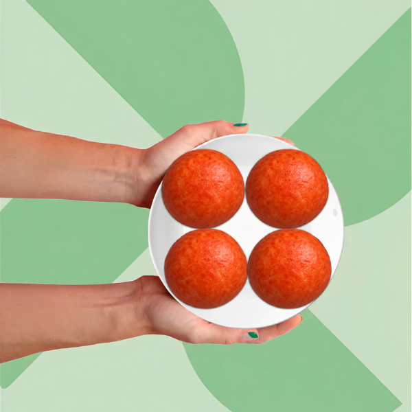 A pair of hands holding a white plate with four Bacon, Egg & Cheese Protein Buns.